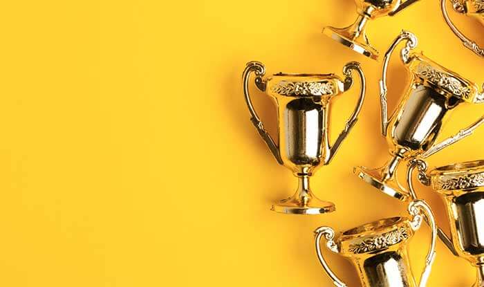 Awards on a yellow background