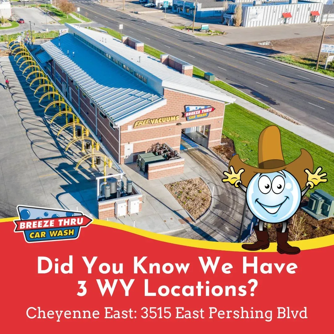 Aerial view of Breeze Thru Car Wash facility with an animated smiling character wearing a cowboy hat. Text overlay highlights three locations in Wyoming, mentioning Cheyenne East on Pershing Blvd.