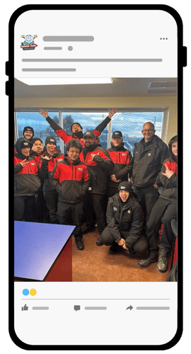 A group of people wearing matching red and black uniforms pose and smile together inside a room, as seen on a smartphone screen displaying a social media post.
